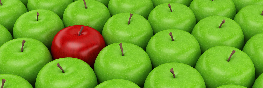 One red apple among a group of green apples