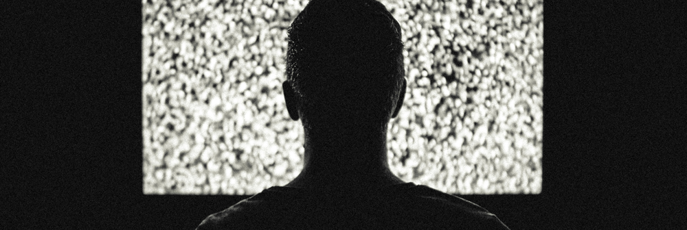 Man watching television in the dark
