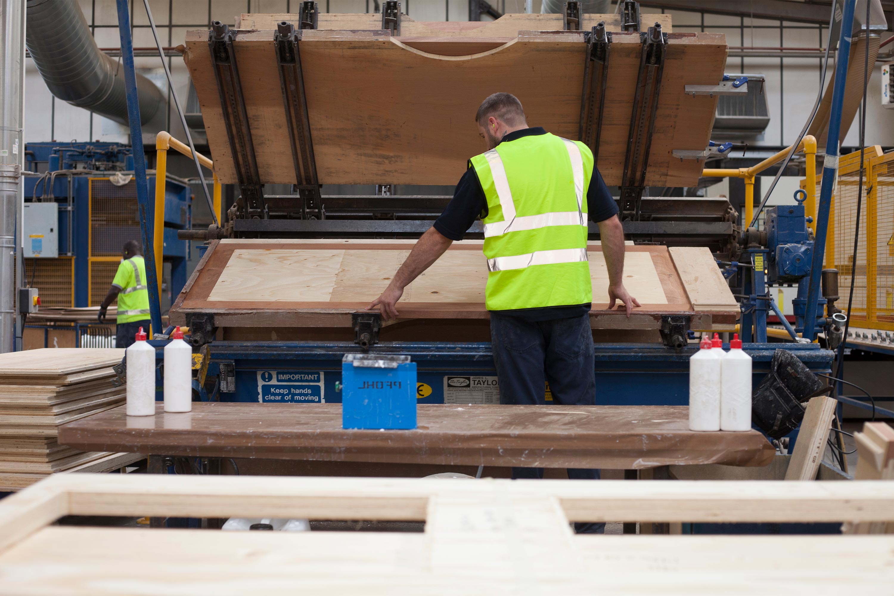 A member of the Warden team producing fire doors at their factory
